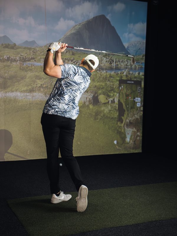 Golfer using the TrackMan simulator at Impact Performance